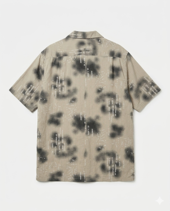 A taupe short-sleeve camp collar shirt featuring abstract black washes and white coded graphics. Bold, modern, and perfect as a statement streetwear piece.