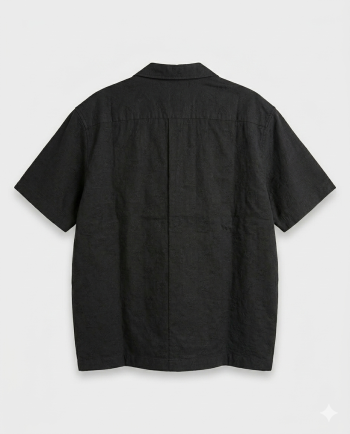 A sleek black short-sleeve shirt with subtle woven texture and a structured relaxed fit. Minimal, versatile, and elevated with quiet luxury energy.